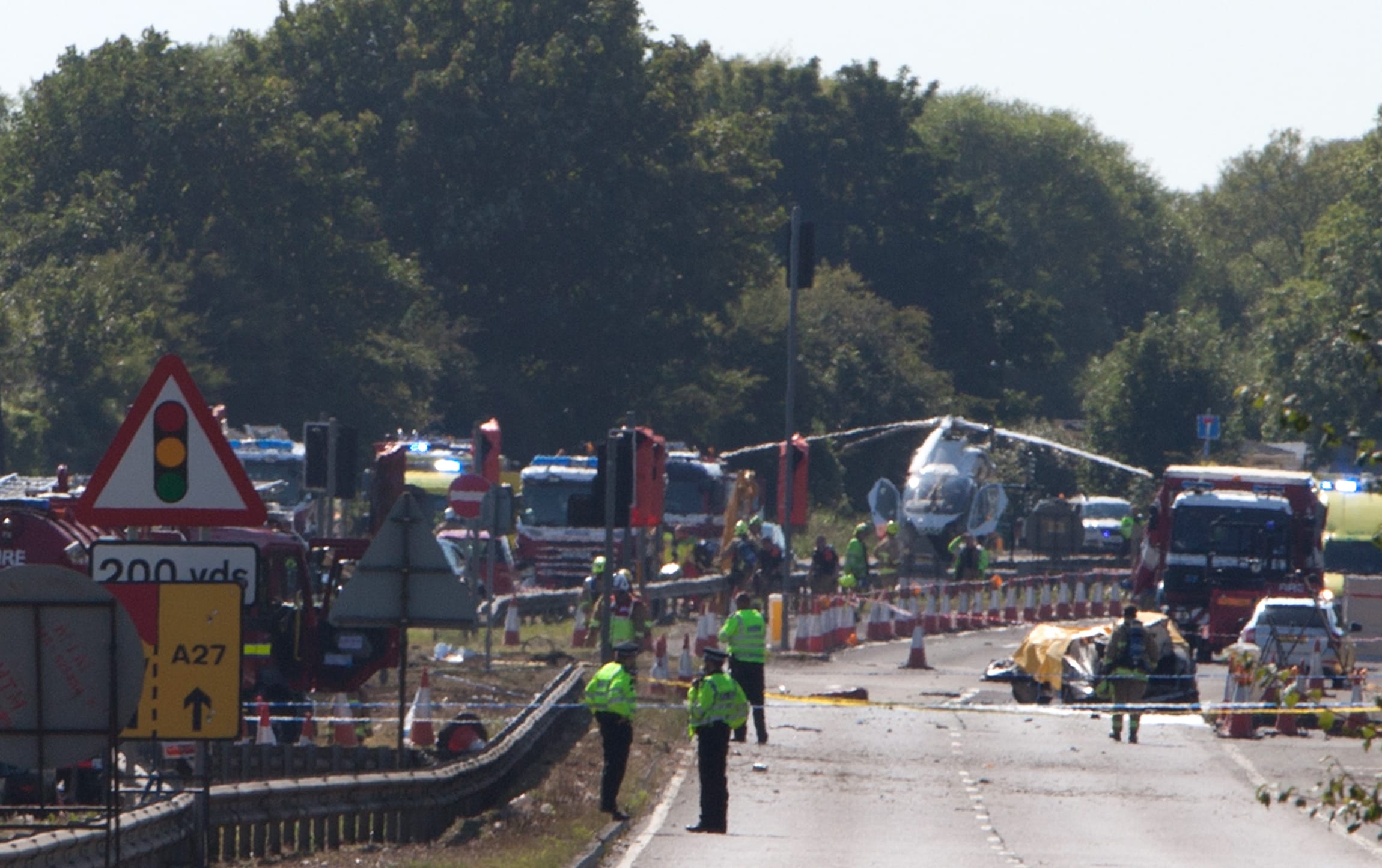 Police and emergency services workers at the scene of a plane crash at Shoreham Air Show, 22 August 2015.