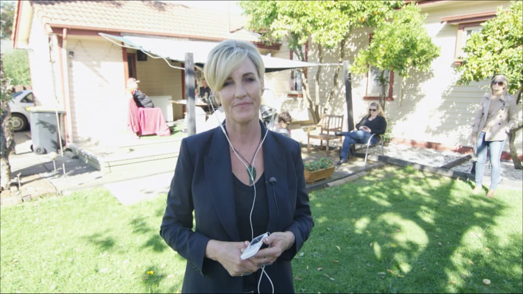 Erin Brockovich talks to John Campbell in the backyard of an earthquake damaged home in Richmond, Christchurch