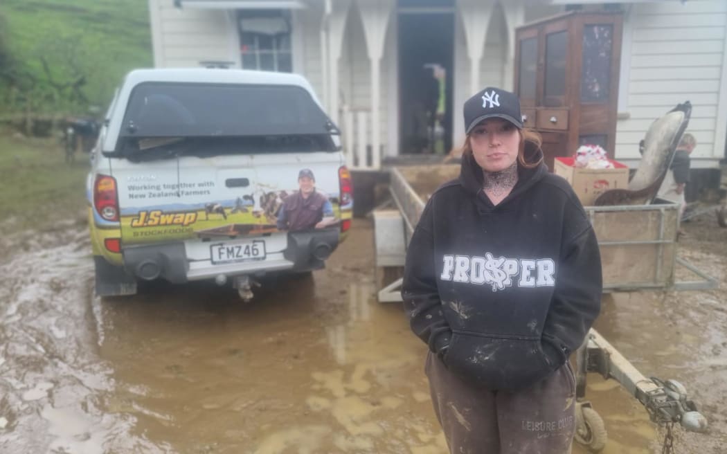 Sharna Wright says flood waters were up to her ribs when she and her brother Jaden rescued the family's cats from her mum's home. Damaged goods piled up outside Christy Wright's cottage.