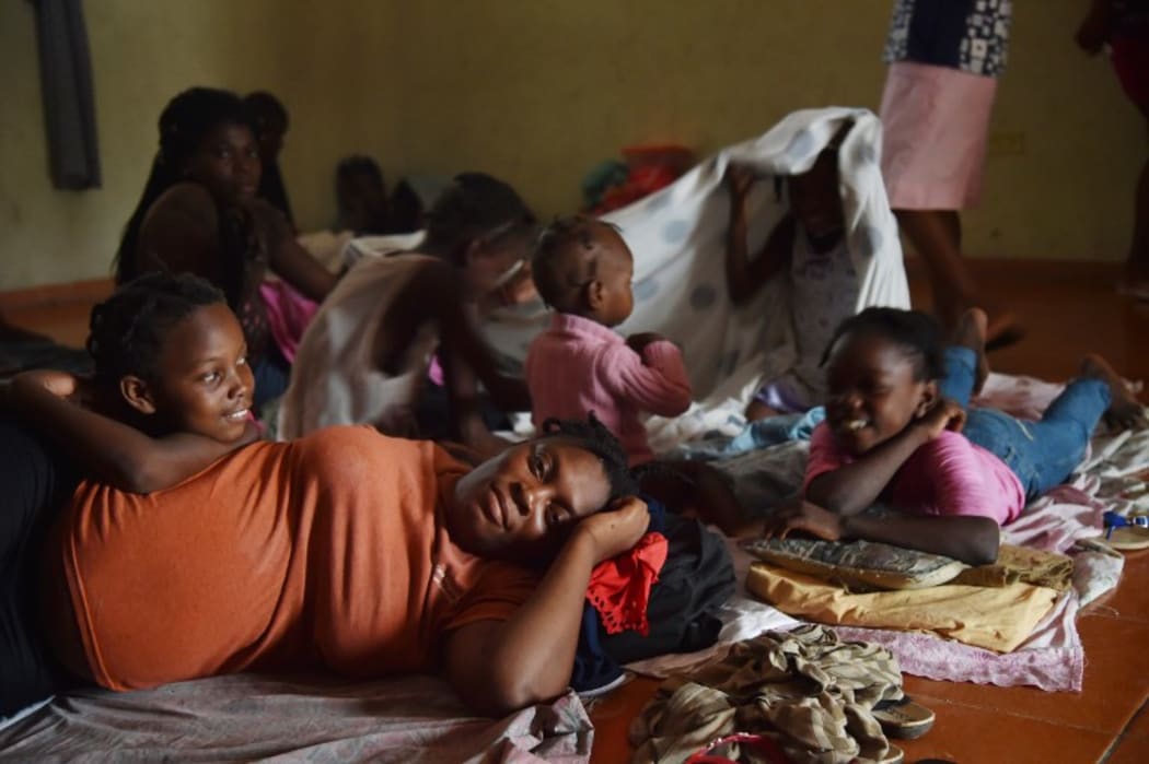 Luisiana and her family shelter at a school after their home was damaged in Port-au-Prince.