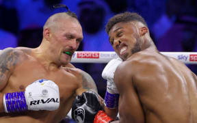 Ukraine's Oleksandr Usyk and Britain's Anthony Joshua compete during the heavyweight boxing rematch for the WBA, WBO, IBO and IBF titles, Saudi Arabia, 2022.