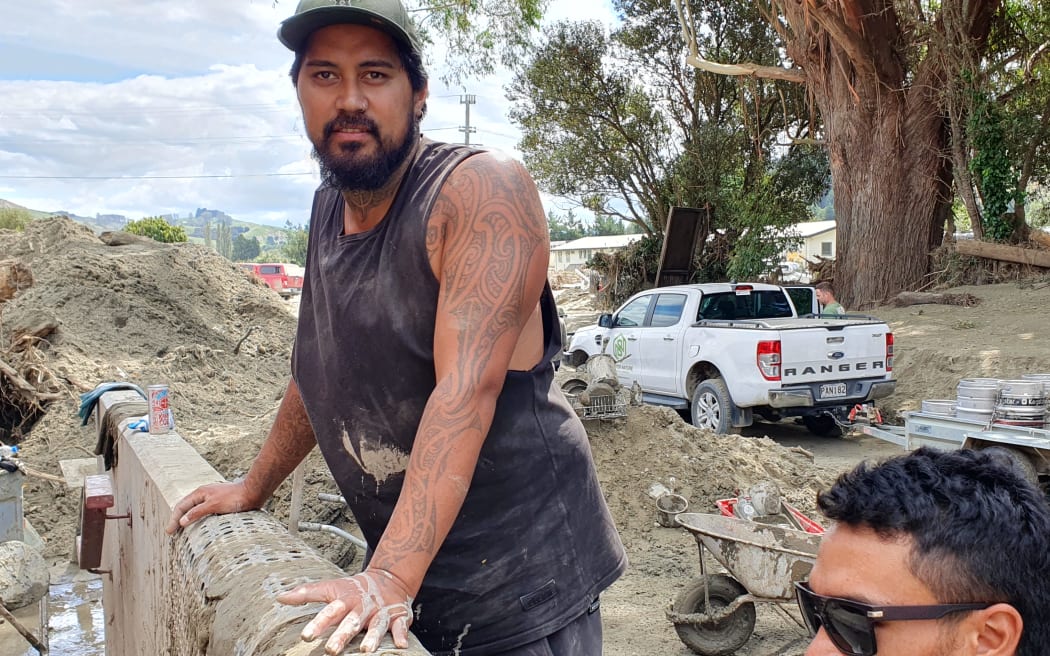 Calvin Thomas has been helping to shovel silt to get to the 12,000 bottles of wine at Petane Wines.