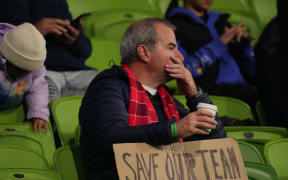 A Rebels supporter in the crowd holds a sign during the Super Rugby Pacific competition, 2024.
