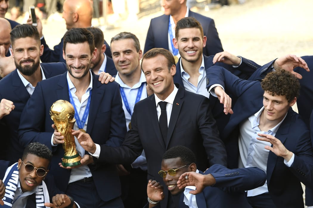 France's Olivier Giroud, Hugo Lloris, French president Emmanuel Macron, France's Paul Pogba, Benjamin Pavard and other teammates at a reception for the French national football team after they won the Russia 2018 World Cup.