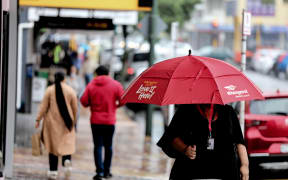 Woman walks in the rain.