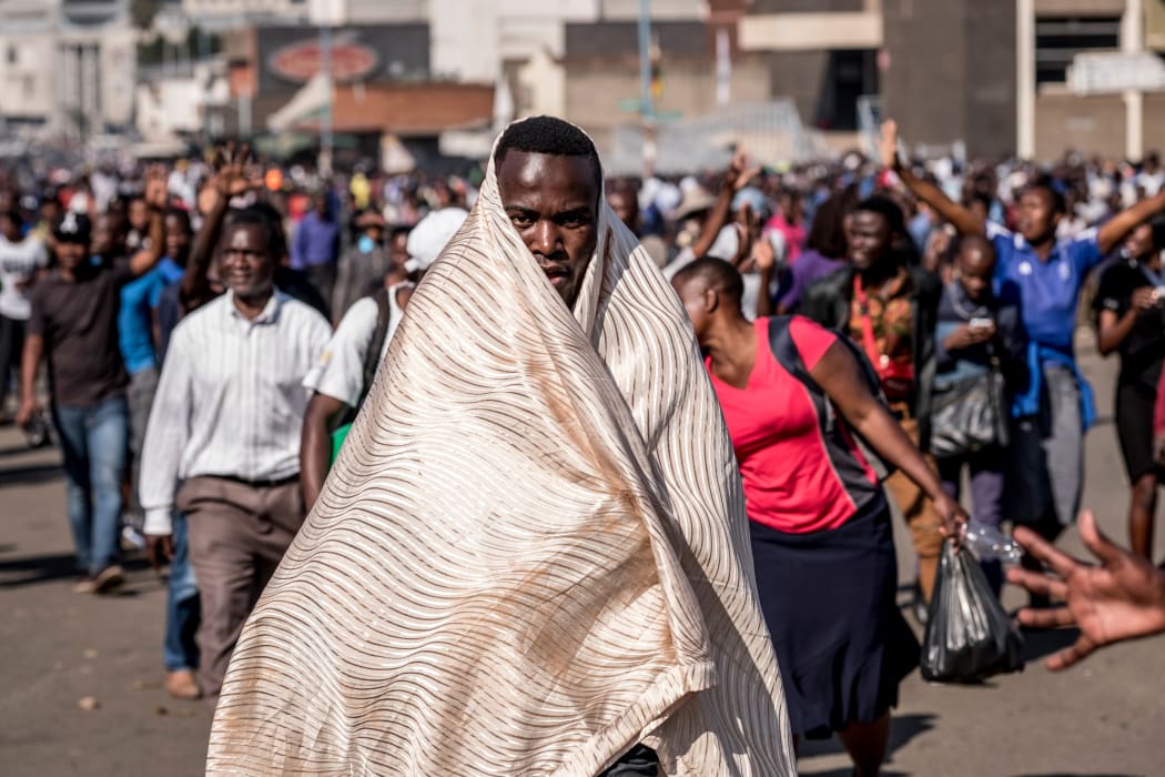 Supporters of Zimbabwe's opposition Movement for Democratic Change (MDC) protest outside the Zimbabwe African National Union Patriotic Front (ZANU-PF) party headquarters in Harare, on August 1, 2018, after protests erupted over alleged fraud in the country's election.