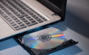 A laptop with compact disc close up shoot