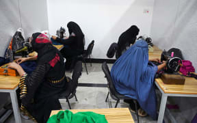 Women work in a tailor workshop at the Khadija Kubra Women's Association for Culture in Kandahar in September 2020,
