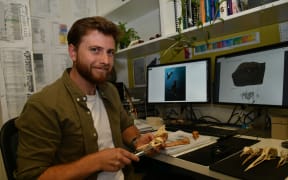 Jacob Blokland pictured with fossils in the Flinders University laboratory.