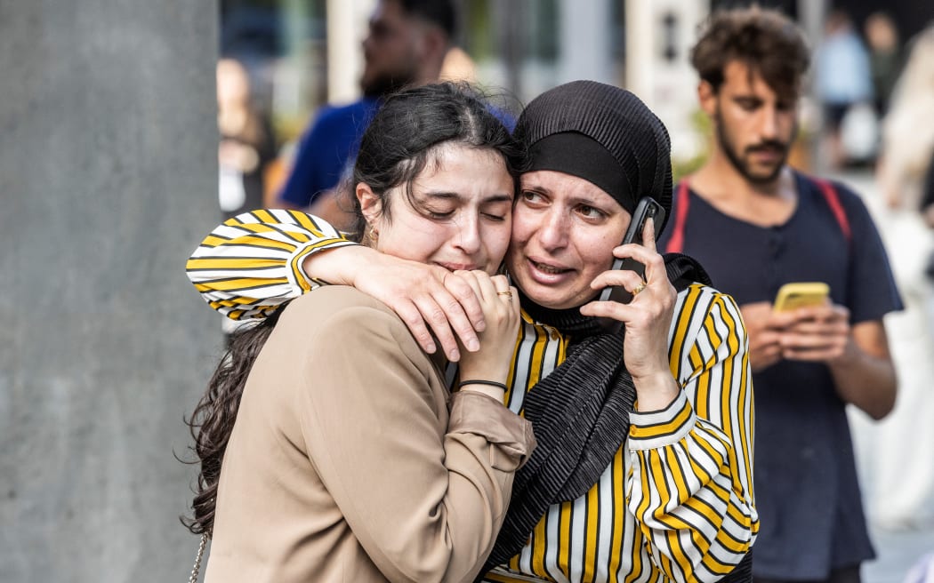 People react outside the Fields shopping mall, where a gunman killed three people and wounded several others in Copenhagen on July 3, 2022. - A 22-year-old Danish man was arrested after the shooting but his motives were unclear, police said. (Photo by Olafur STEINAR GESTSSON / Ritzau Scanpix / AFP) / Denmark OUT