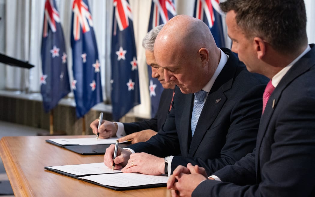 Coalition agreement signing ceremony between Christopher Luxon, David Seymour and Winston Peters.