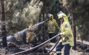 170224 CHRIS SKELTON / POOL
Firefighters continue their efforts on Saturday as they work to dampen down remaining hot spots and create a buffer zone around the 24km perimeter fire ground in Christchurch's Port Hills. Pictured Rural firefighter Aaron Kinnane (City Care firefighter)