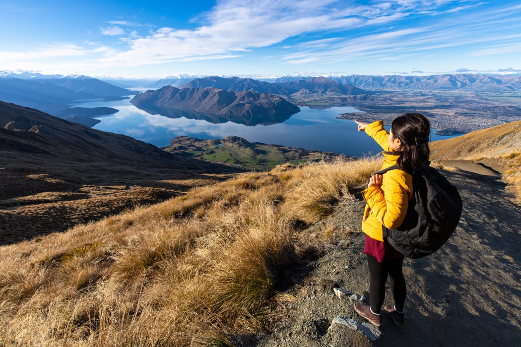 Young person hiking on Roys peak track, Wanaka, South Island, New Zealand