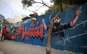 A picture taken on January 4, 2018, shows a mural of Ibrahim Abu Thurayeh, who was shot dead in clashes between Israeli forces and protesters along the Gaza-Israel border in December.
painted on a wall in Gaza City.