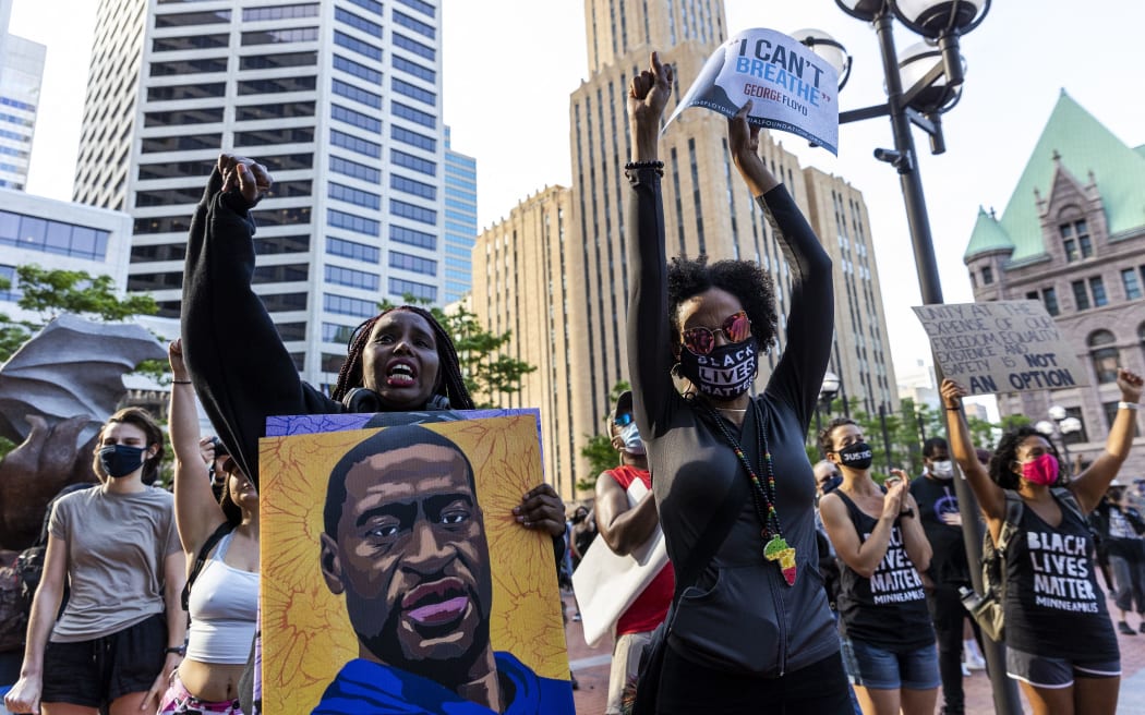 People raise their fists as they march during an event in remembrance of George Floyd in Minneapolis, Minnesota, on 23 May 2021.