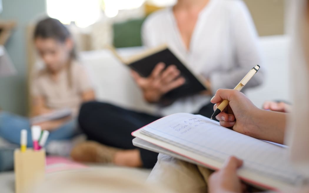 Group of homeschooling children with parent teacher studying indoors, coronavirus concept.
