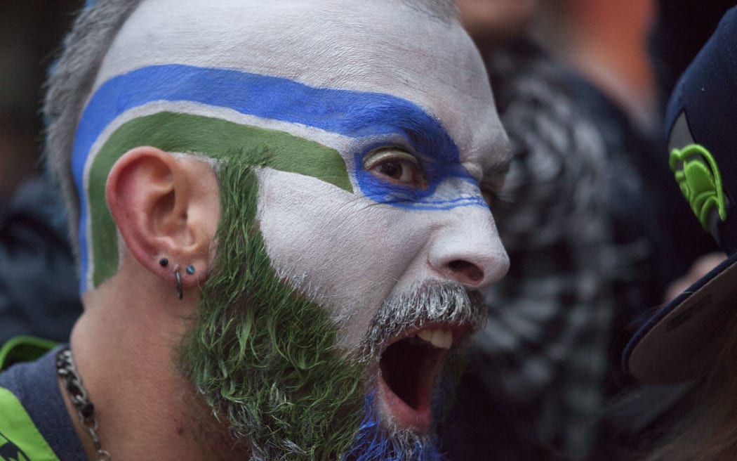 Seattle Seahawks fan Dustin Pittis cheers as he watches Super Bowl.