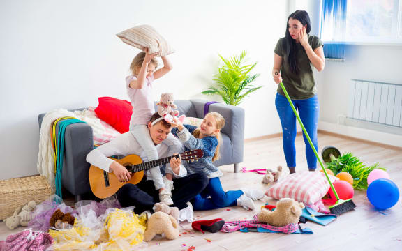 Mother is cleaning mess after her daughters played