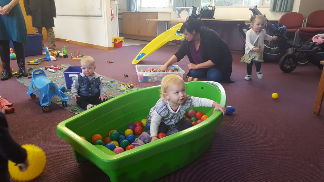 Uiga Bashford (one of the parents behind the Phillipstown Mums and Bubs sessions) organises the toys while Theodore Calvert, Marina Miles and Indiana get down to some serious playing.
