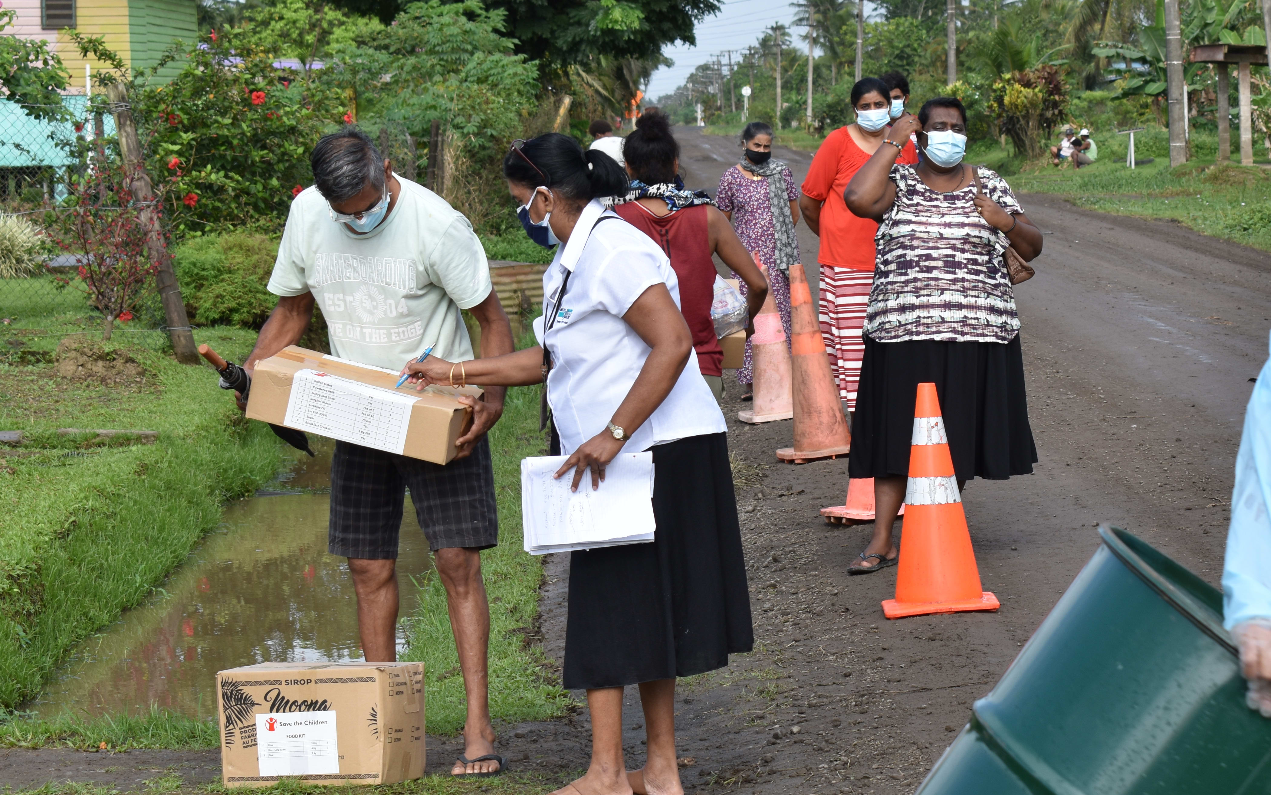 People lining up to get food supplied from Save the Children on the main island Viti Levu.