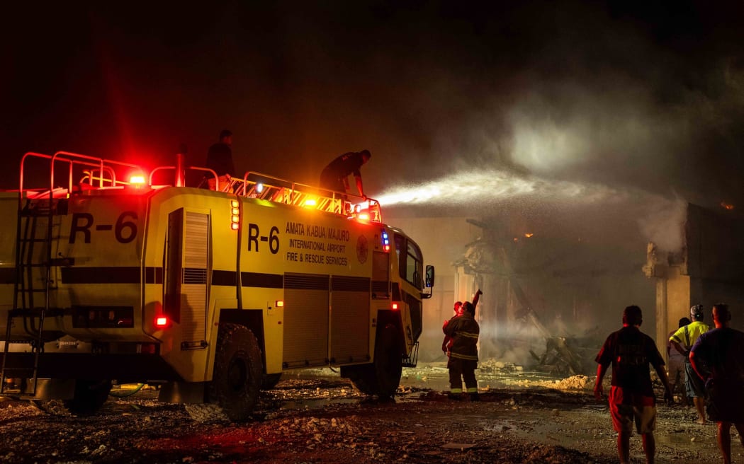 Marshall Islands firefighters try to contain the fire.