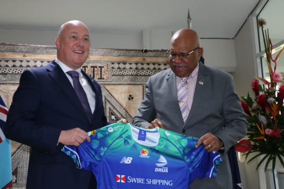 New Zealand Prime Minister Christopher Luxon and Fiji Prime Minister Sitiveni Rabuka have met ahead of their bilateral. Rabuka gave Luxon, a Crusaders fan, a Fijian Drua shirt which Luxon took in his stride. Luxon gifted Rabuka with a Hoehner harmonica, one of only three in New Zealand.