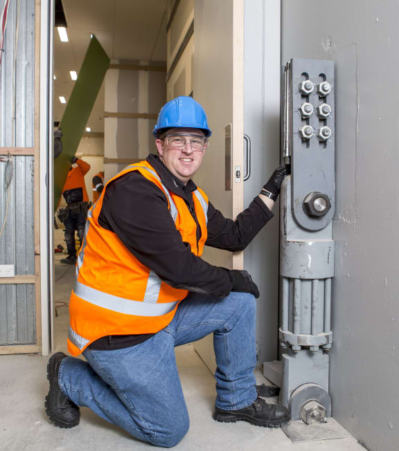 Geoff Rodgers with a seismic damper used in the new Christchurch library, Tūranga.