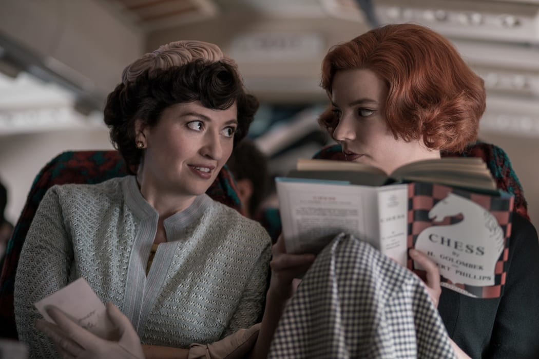 L-R: Alma Wheatley (Marielle Heller) is the adopted mother of orphan chess prodigy of Beth Harmon (Anya Taylor-Joy).