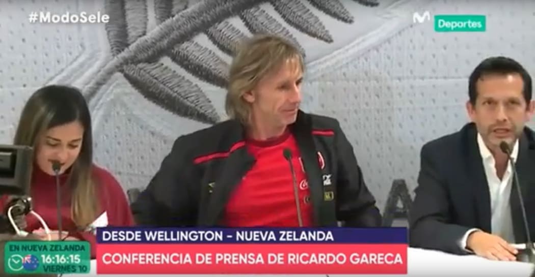 Carlos Gonzales (right) translating for Peru's coach Ricardo Gareca in a press conference seen by millions live in Peru.