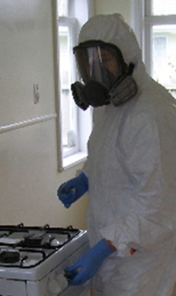 Testing meth residues in a clan lab kitchen.