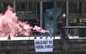 Activists from the Ocean Rebellion group protest outside the International Maritime Organization (IMO) at the end of the 80th Marine Protection Committee (MEPC) conference in London on July 7, 2023. The International Maritime Organization, overseer of the highly-polluting shipping industry, sealed a landmark deal Friday to improve its target to cut carbon emissions but green campaigners said it fell far short. (Photo by HENRY NICHOLLS / AFP)