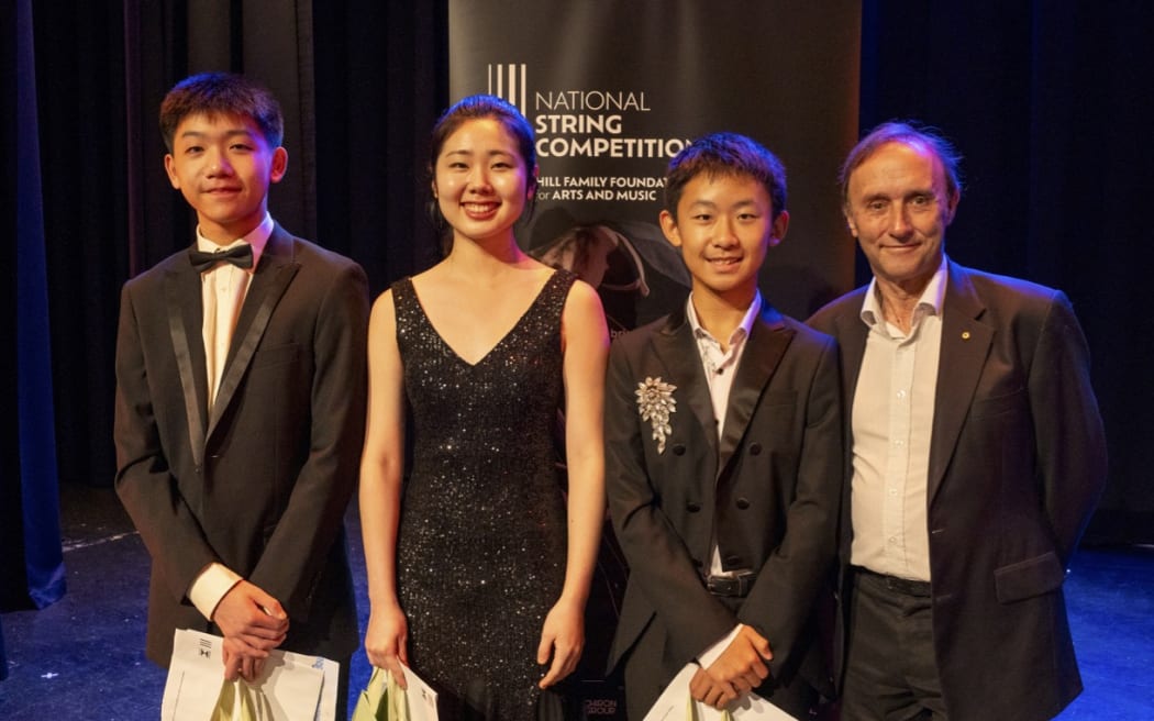 Three finalists of the 2024 National String Competition, Hayden Chiu, Sarah Lee and Ryan Yeh pose with adjudicator Dene Olding.
