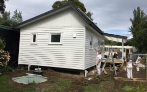 The exterior of the house as painters put finishing touches on.