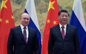 Russian President Vladimir Putin (left) and Chinese President Xi Jinping pose during their meeting in Beijing, on February 4, 2022.