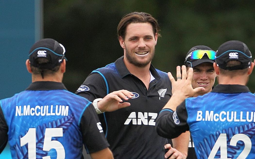Mitchell McClenaghan of the Black Caps is congratulated by Nathan McCullum and Brendon McCullum during the first ODI cricket game between the Black Caps and Sri Lanka.