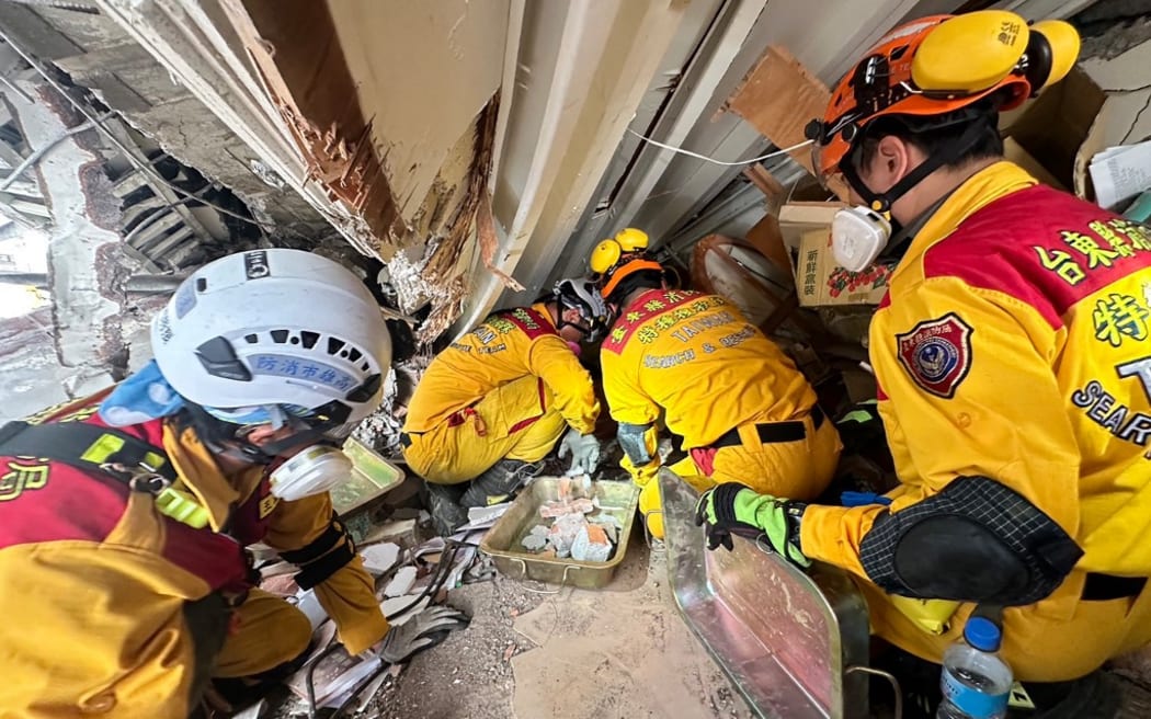 Members of a rescue team searching for survivors in a damaged building in Hualien, after a major earthquake hit Taiwan's east on 3 April, 2024.