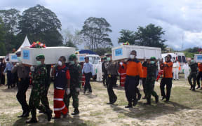 Indonesian rescue personnel load coffins bearing bodies recovered from the underwater wreckage of AirAsia flight QZ850.