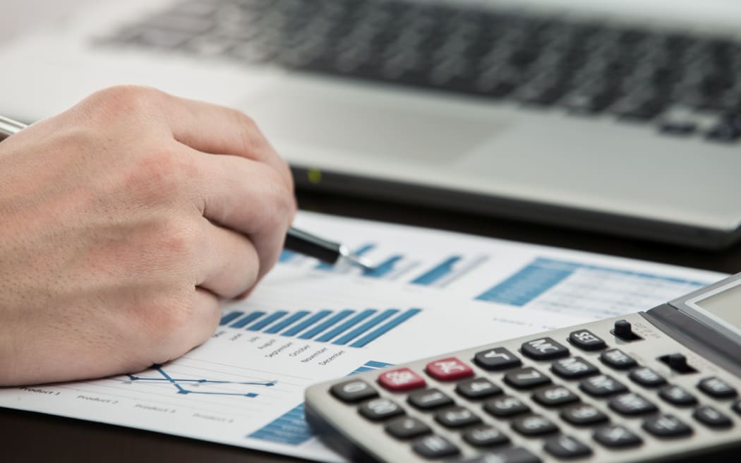 Businessman analyzing investment charts with laptop