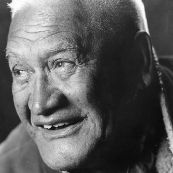 Wiremu (Bill) Kerekere is a smiling man with a gap between his front teeth and cropped white hair.
