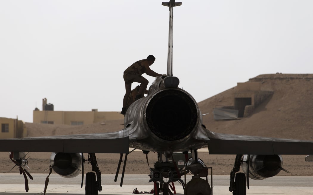 A French army technician inspecting a Mirage 2000 fighter jet at a base in Jordan, 12 October 2015.