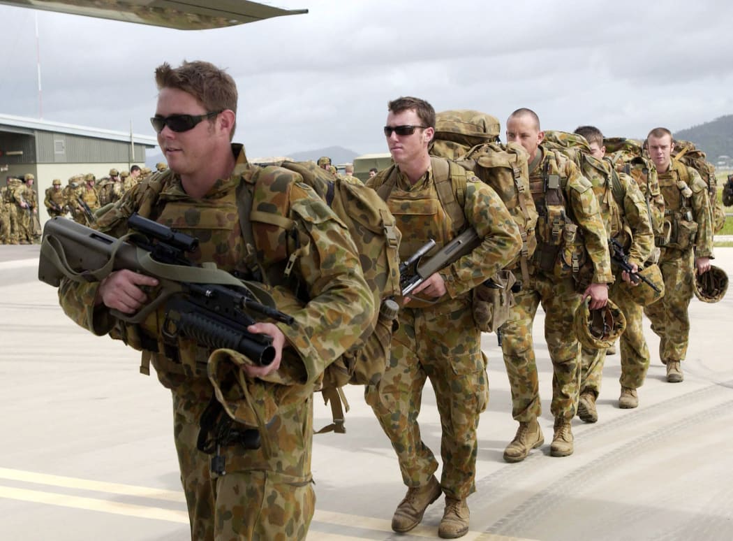 Soldiers from Delta Company, 1st Royal Australian Regiment board an Australian Air Force aircraft at Townsville, 19 April 2006, for the Solomon Islands.