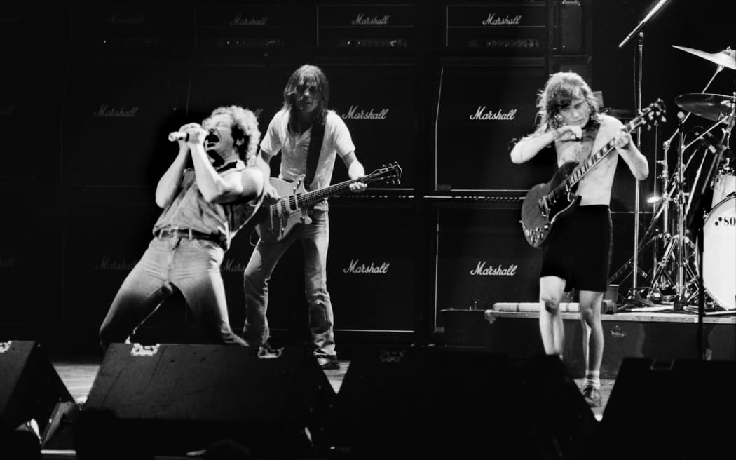 (Left to right) Singer Brian Johnson performs next to guitarists Malcolm Young and Angus Young of Australian legendary hard rock band AC/DC at the Palais Omnisport of Paris Bercy, on September 15, 1984 in Paris.
