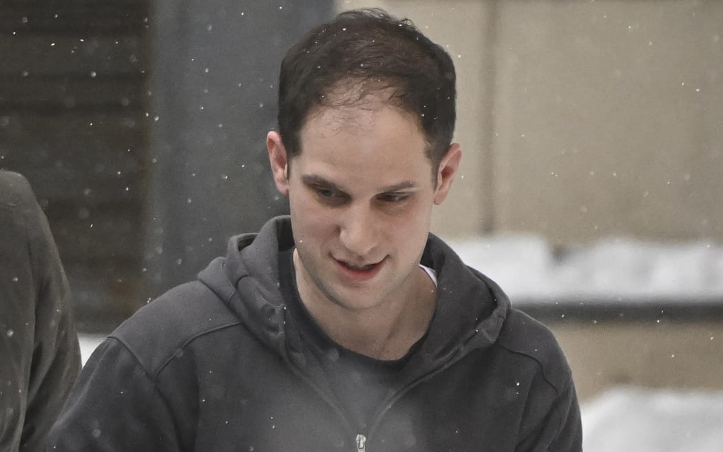 US journalist Evan Gershkovich, who was detained last March on spying charges during a reporting trip to the Urals, is escorted out of the Lefortovsky Court building in Moscow on January 26, 2024. A Moscow court on January 26, 2024 extended until March 30 the detention of Evan Gershkovich, an American Wall Street Journal reporter held in Moscow on espionage charges which he denies. (Photo by Alexander NEMENOV / AFP)