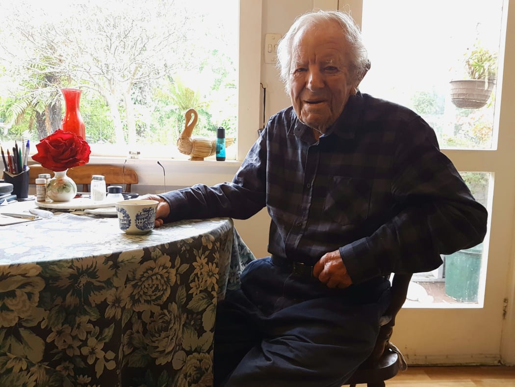 A photo of Baden Norris in his kitchen with a cup of tea