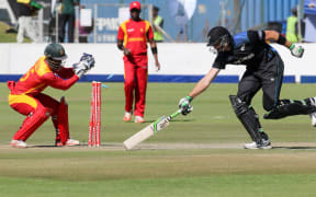 New Zealand's batsman Martin Guptill survives a run out attempt by Zimbabwe's wicketkeeper Regis Chakabva (L) during the second one-day international cricket match between Zimbabwe and New Zealand at Harare Sports Club on August 4, 2015.