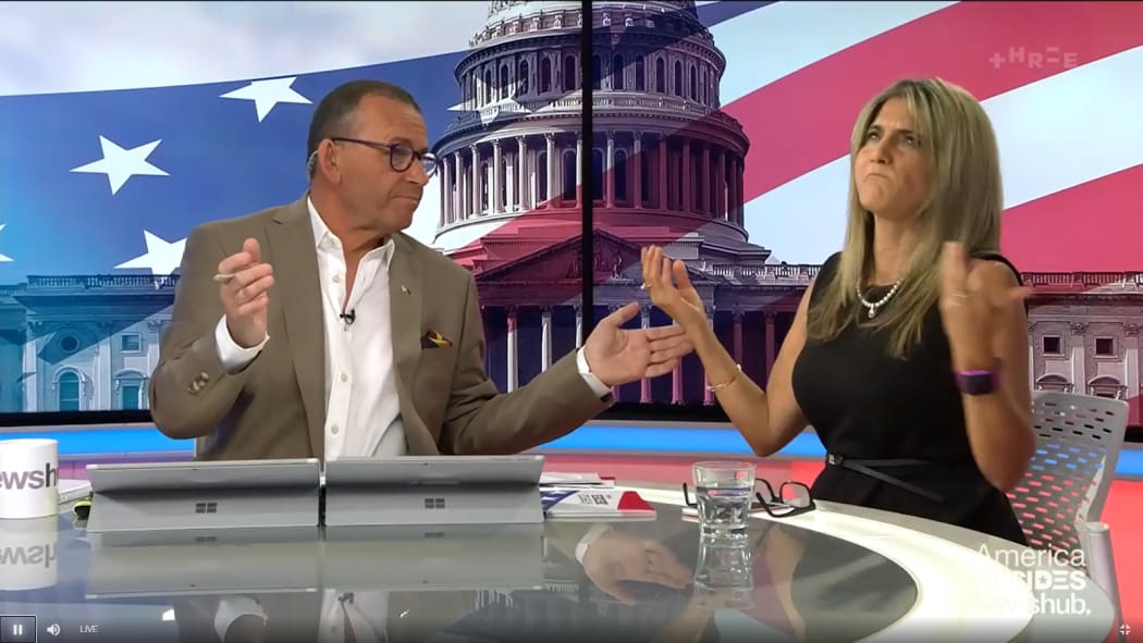 Newshub host Paul Henry and guest Maria Armoudian throw their hands in the air.