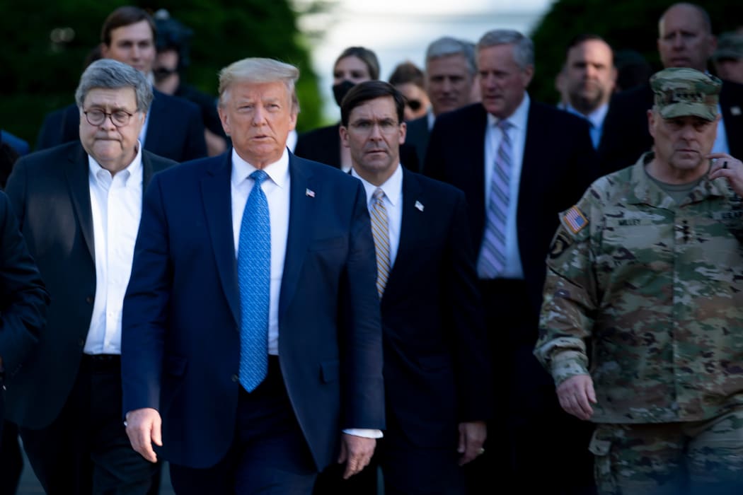 US President Donald Trump walks with Attorney General William Barr, left, Secretary of Defense Mark T. Esper, centre, Chairman of the Joint Chiefs of Staff Mark A. Milley, right, and others to visit St John's Church after the area was cleared of protesters, on 1 June.