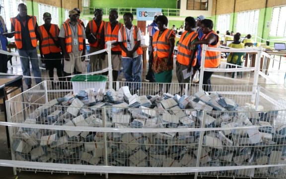 Scrutineers oversee the mixing bin.