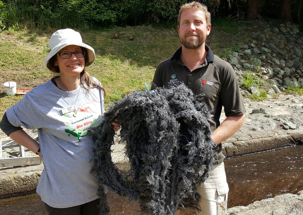 Michelle Duckett from Enviroschools and Travis Moody from Greater Wellington Regional Council. Travis is holding a mussel farm rope, that will be put in the stream behind to help fish swim upstream against the water flow.