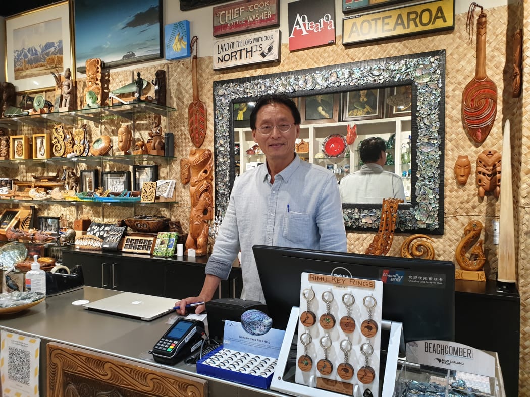 Benny Li, who has been operating souvenir shops on Auckland’s Queen St, is closing one of his two shops. He says businesses like his are struggling and hopes the trans-Tasman bubble can be up and running soon.